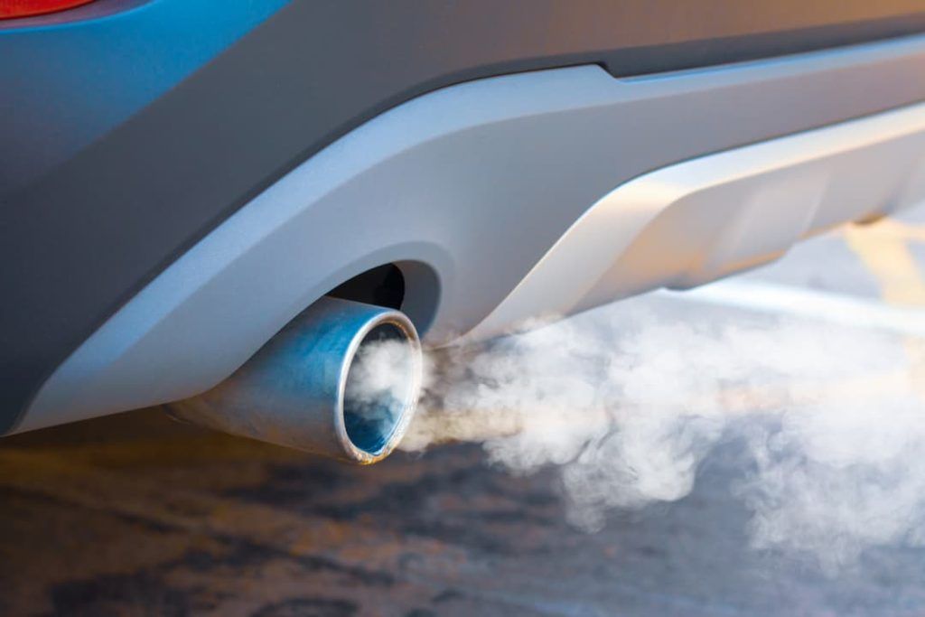a car exhaust pipe with smoke coming out of it